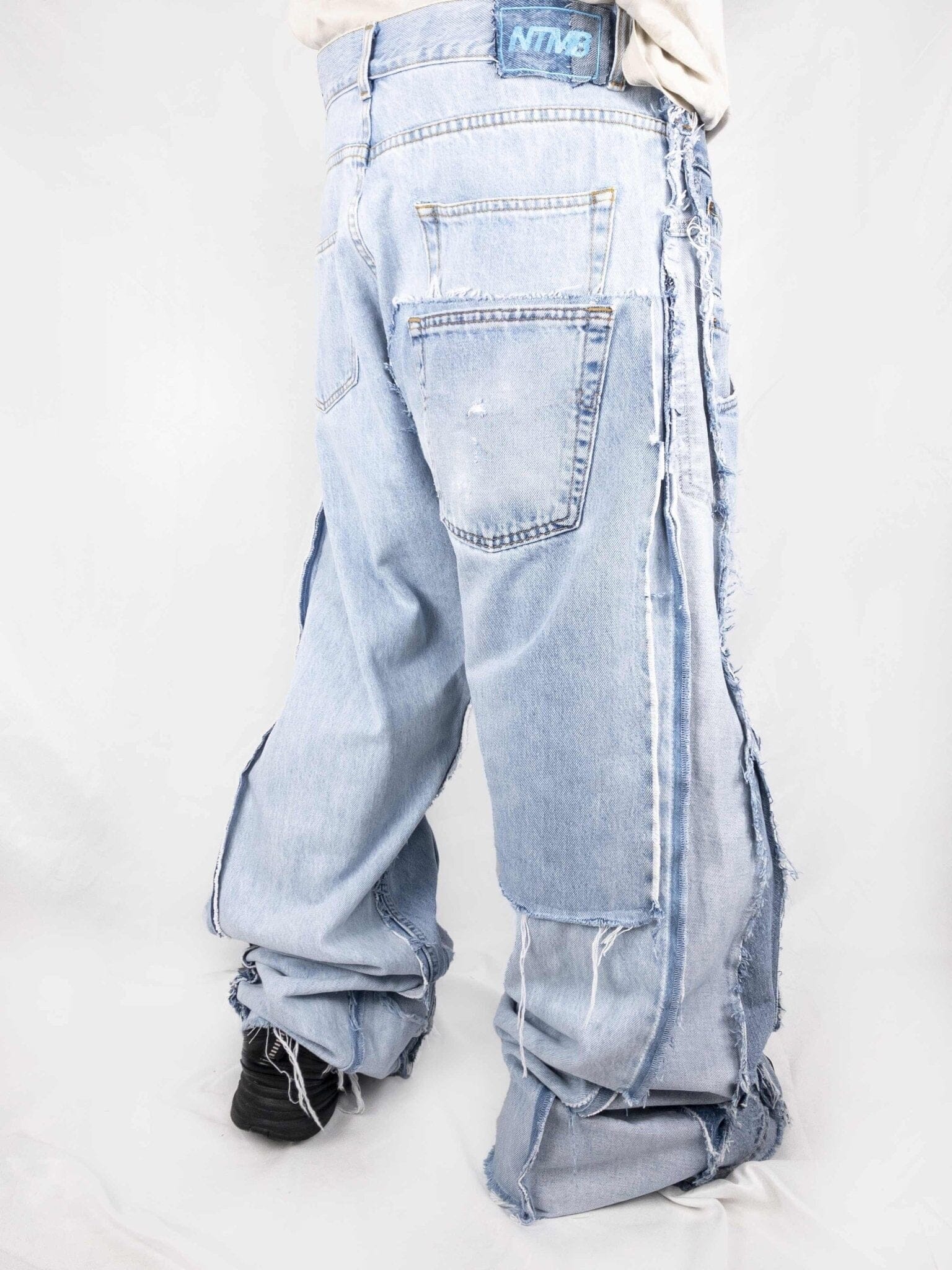 Triple Jeans Light Blue – wide leg denim made from 3 vintage jeans. Light blue stonewash, raw edges, and oversized unisex fit. Unique reconstructed streetwear design.
